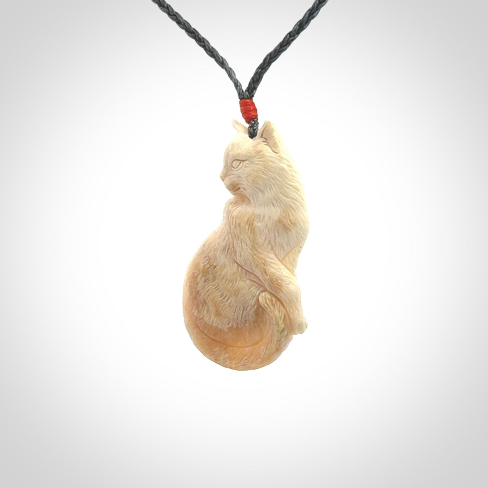 Hand carved bone cat pendant