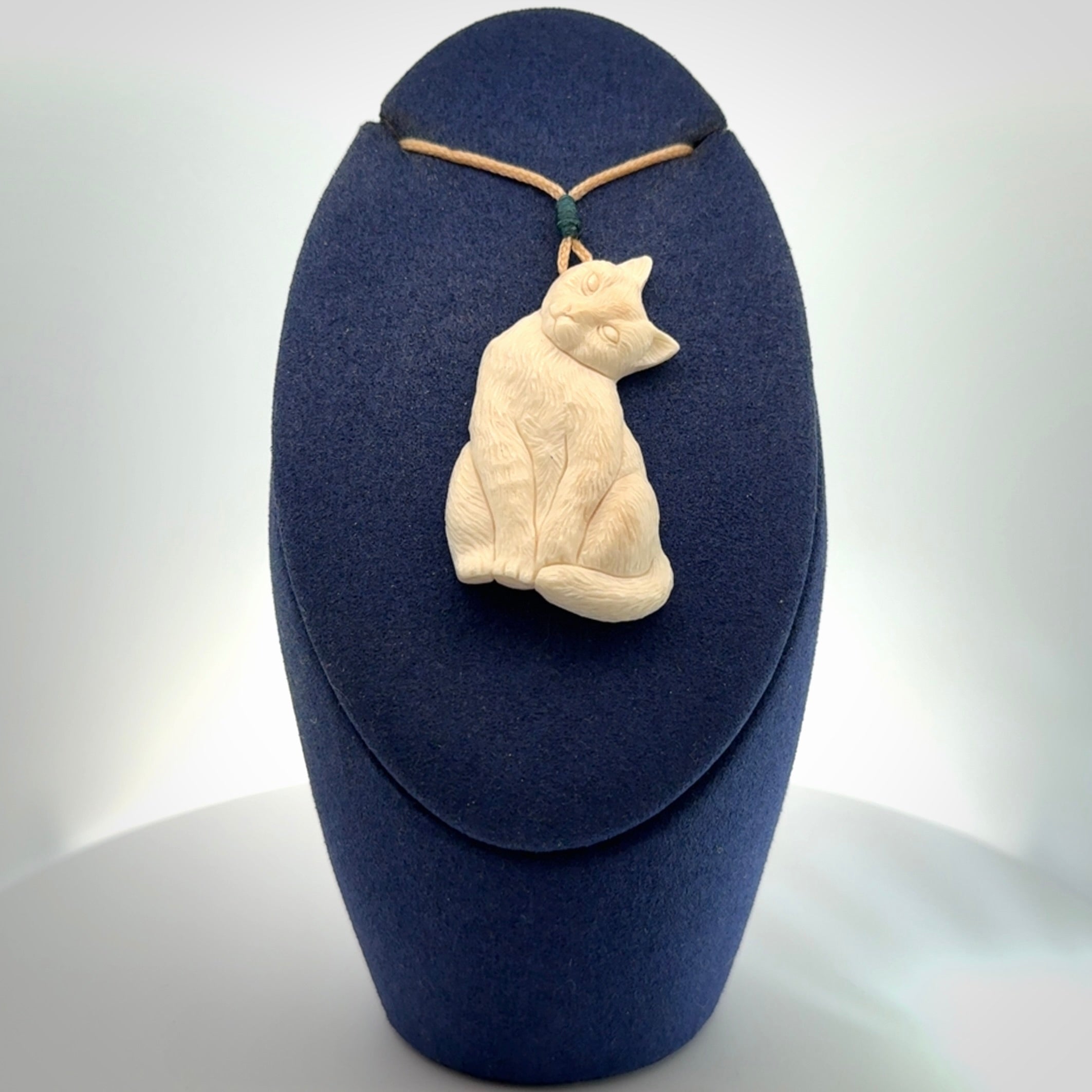 Hand carved bone cat pendant