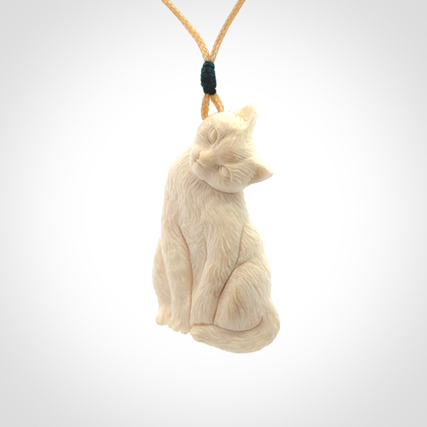 Hand carved bone cat pendant