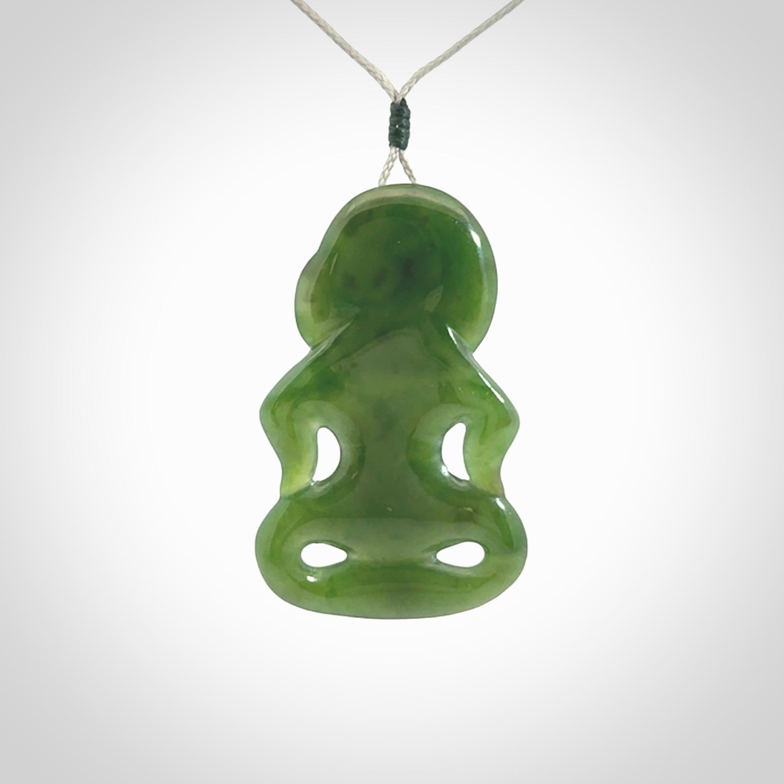 This pendant is a large jade tiki pendant. The carving shows wonderful detail on the front while the back is beautifully rounded. These are carved in Columbian Jade. The cord is adjustable in length. Provided in a woven kete pouch and shipped worldwide.