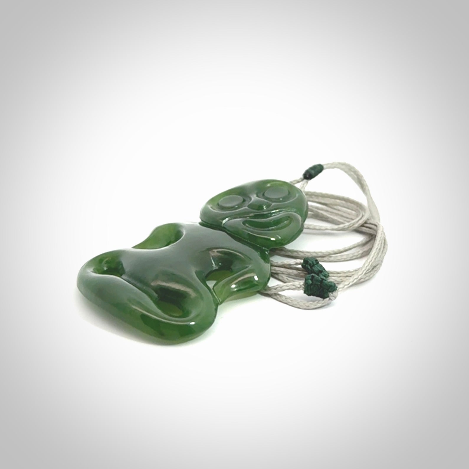 This pendant is a large jade tiki pendant. The carving shows wonderful detail on the front while the back is beautifully rounded. These are carved in Columbian Jade. The cord is adjustable in length. Provided in a woven kete pouch and shipped worldwide.
