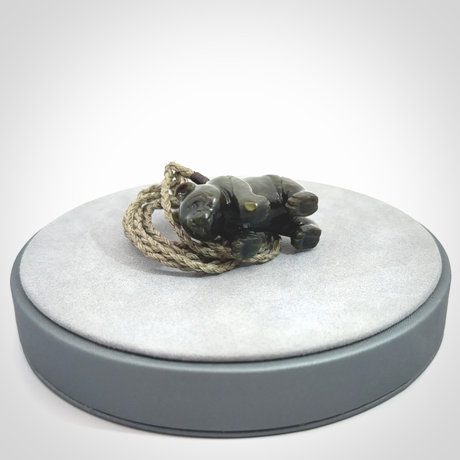 This picture shows a pendant that we designed in New Zealand jade. It is a little green bear that has a walking stance and is carved in detail. A really attractive and eye-catching piece of handmade jewellery. The cord is hand plaited braid and the length can be adjusted.