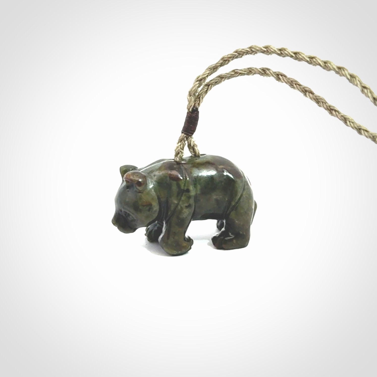 This picture shows a pendant that we designed in New Zealand jade. It is a little green bear that has a walking stance and is carved in detail. A really attractive and eye-catching piece of handmade jewellery. The cord is hand plaited braid and the length can be adjusted.