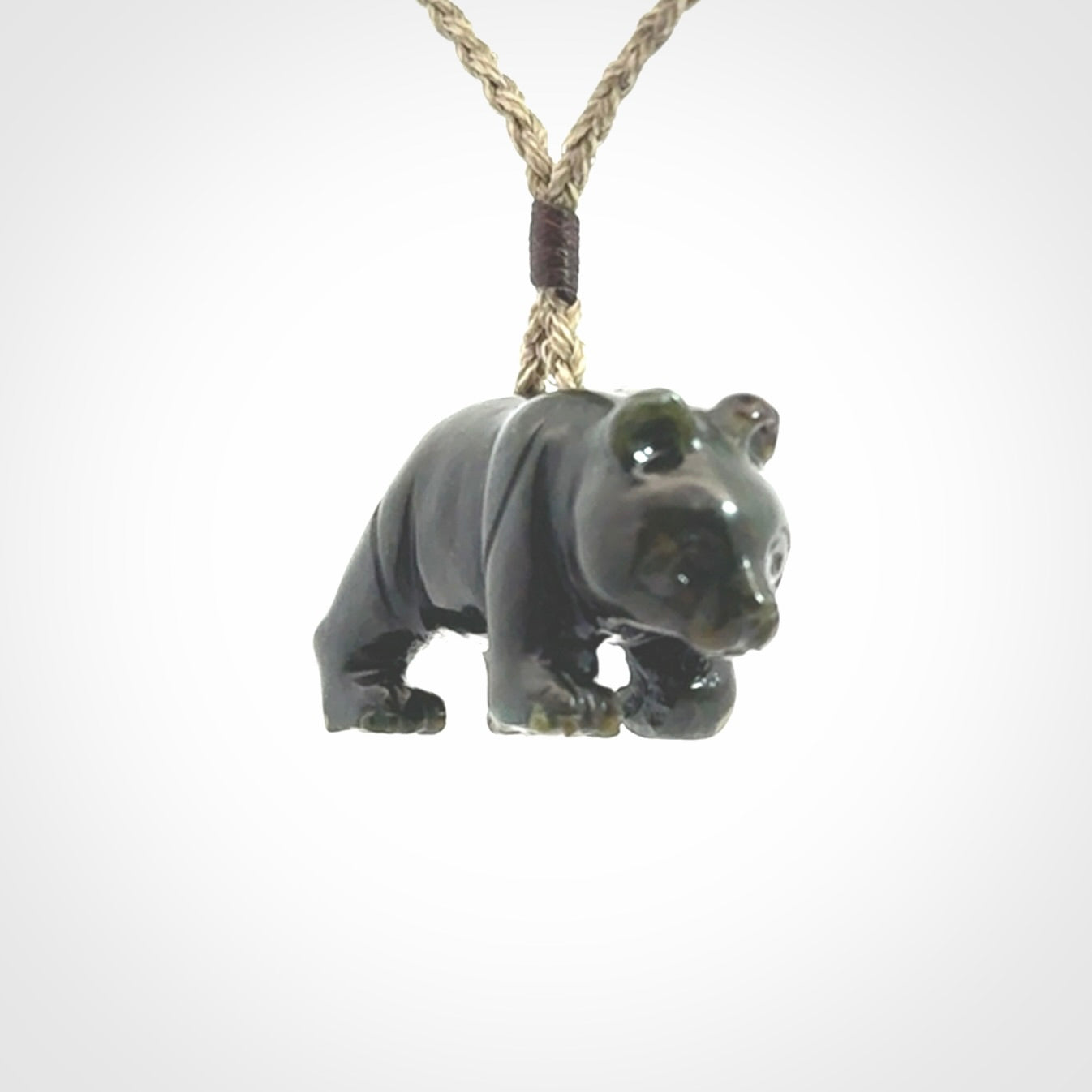 This picture shows a pendant that we designed in New Zealand jade. It is a little green bear that has a walking stance and is carved in detail. A really attractive and eye-catching piece of handmade jewellery. The cord is hand plaited braid and the length can be adjusted.