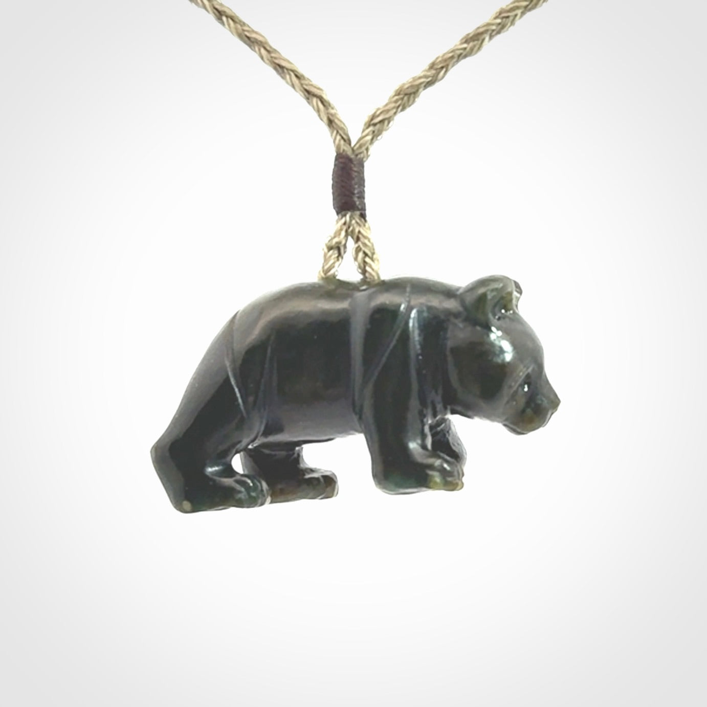 This picture shows a pendant that we designed in New Zealand jade. It is a little green bear that has a walking stance and is carved in detail. A really attractive and eye-catching piece of handmade jewellery. The cord is hand plaited braid and the length can be adjusted.