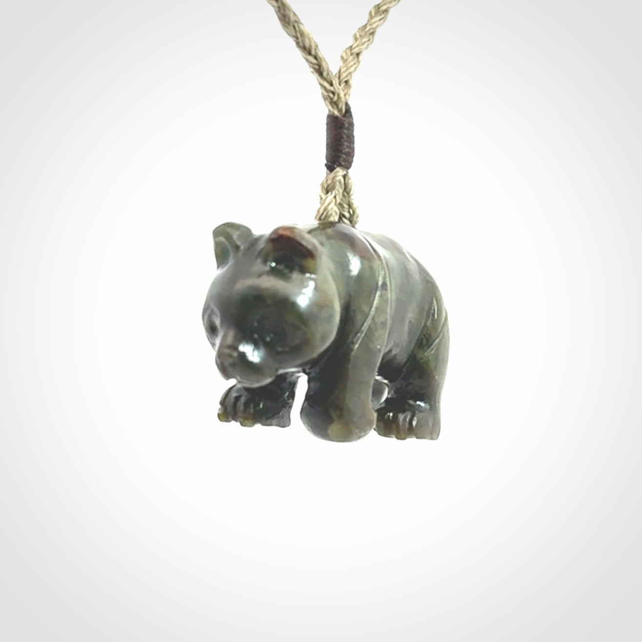 This picture shows a pendant that we designed in New Zealand jade. It is a little green bear that has a walking stance and is carved in detail. A really attractive and eye-catching piece of handmade jewellery. The cord is hand plaited braid and the length can be adjusted.