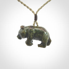 This picture shows a pendant that we designed in New Zealand jade. It is a little green bear that has a walking stance and is carved in detail. A really attractive and eye-catching piece of handmade jewellery. The cord is hand plaited braid and the length can be adjusted.
