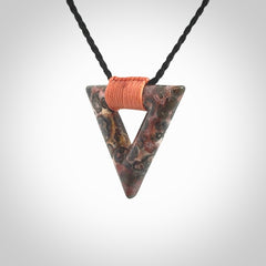 This is a hand carved triangle pendant made from a gorgeous and striking piece of Tiger Jasper. This is a hand carved and very unique necklace. For sale online from NZ Pacific. Delivered with adjustable cord.