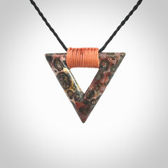 This is a hand carved triangle pendant made from a gorgeous and striking piece of Tiger Jasper. This is a hand carved and very unique necklace. For sale online from NZ Pacific. Delivered with adjustable cord.