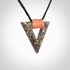 This is a hand carved triangle pendant made from a gorgeous and striking piece of Tiger Jasper. This is a hand carved and very unique necklace. For sale online from NZ Pacific. Delivered with adjustable cord.