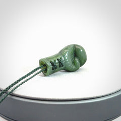 Hand carved boxing glove made from Jade. The cord is adjustable so that you can wear this where it suits you best. The cost of shipping worldwide is included in the price.