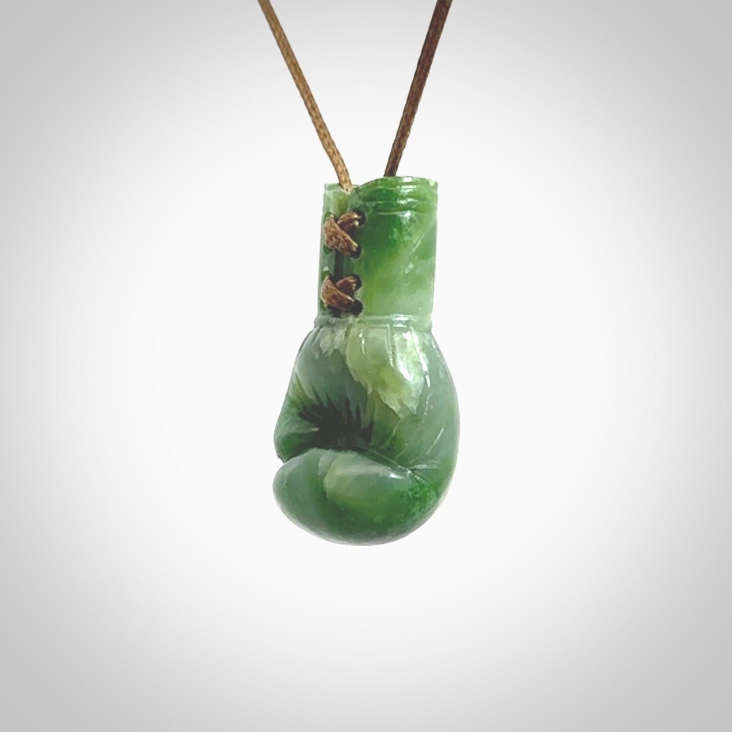 Hand carved boxing glove made from Jade. The cord is adjustable so that you can wear this where it suits you best. The cost of shipping worldwide is included in the price.