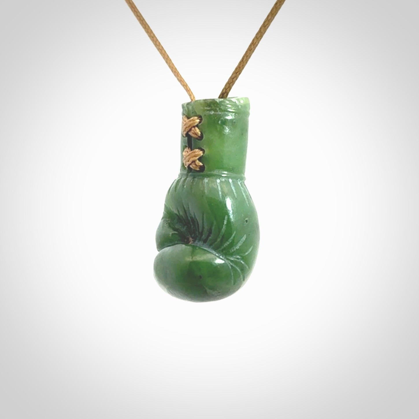 Hand carved boxing glove made from Jade. The cord is adjustable so that you can wear this where it suits you best. The cost of shipping worldwide is included in the price.