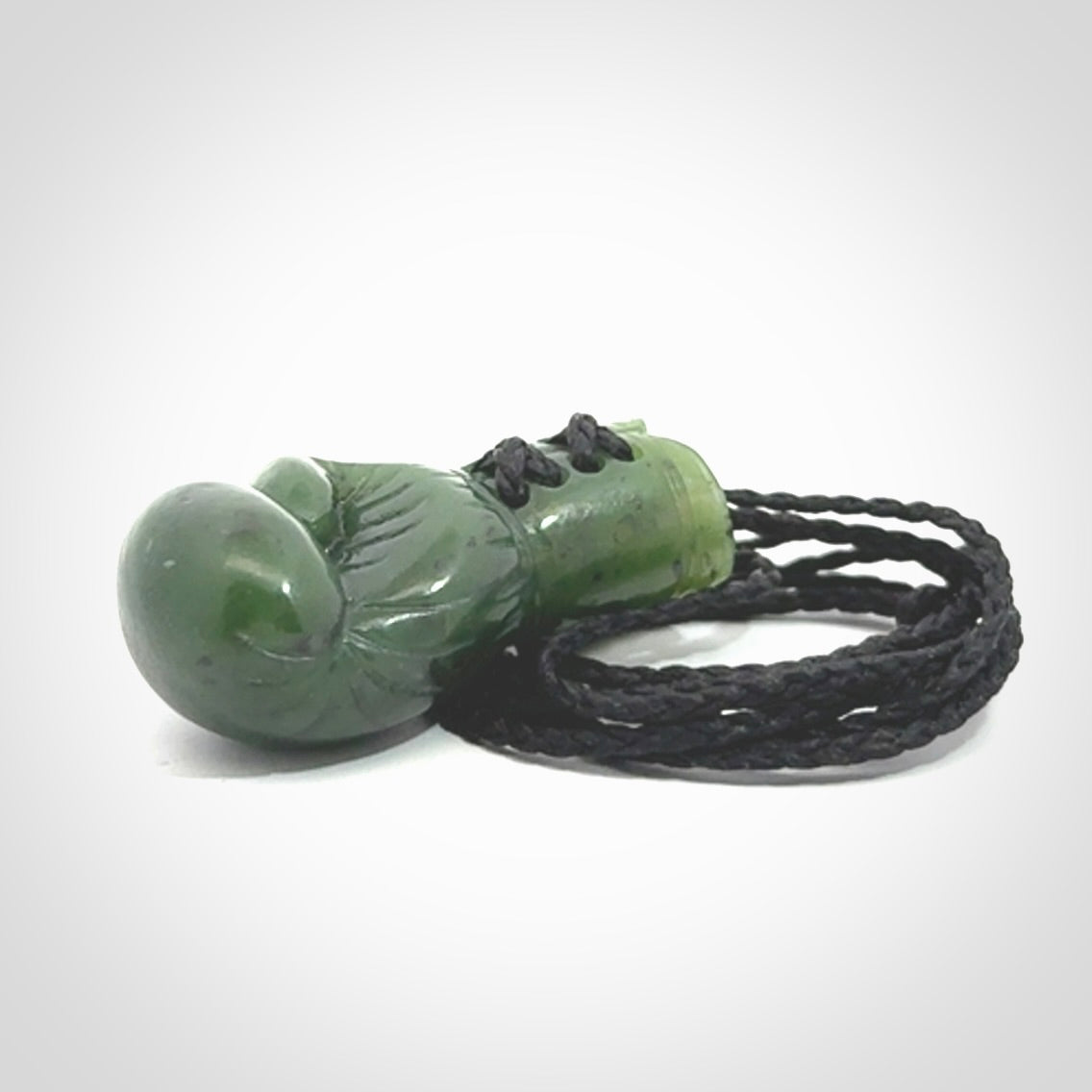 Hand carved boxing glove made from Jade. The cord is adjustable so that you can wear this where it suits you best. The cost of shipping worldwide is included in the price.