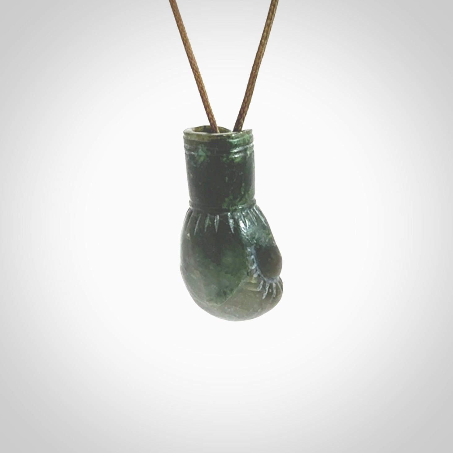 Hand carved boxing glove made from New Zealand Jade. The cord is adjustable so that you can wear this where it suits you best. The cost of shipping worldwide is included in the price.