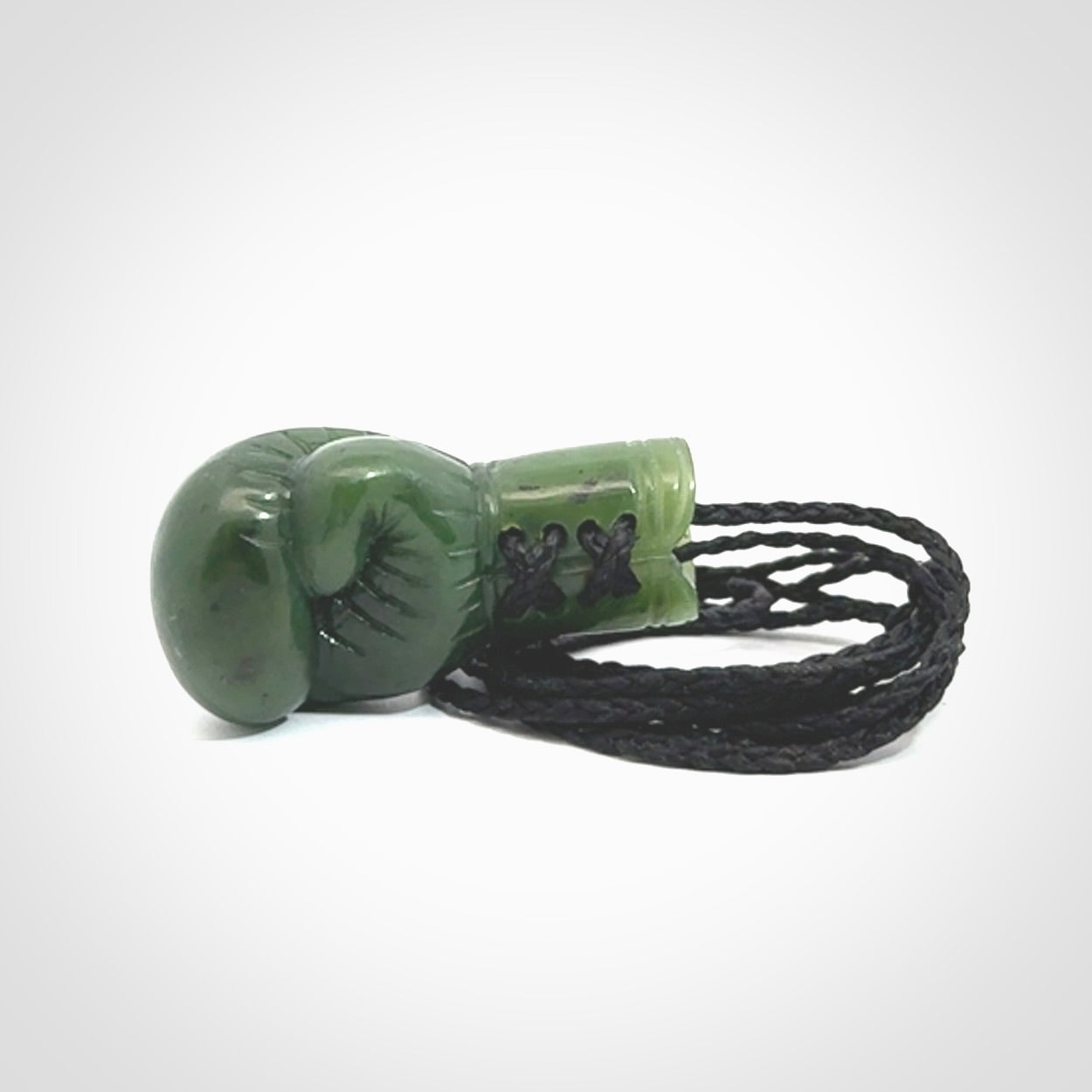 Hand carved boxing glove made from Jade. The cord is adjustable so that you can wear this where it suits you best. The cost of shipping worldwide is included in the price.
