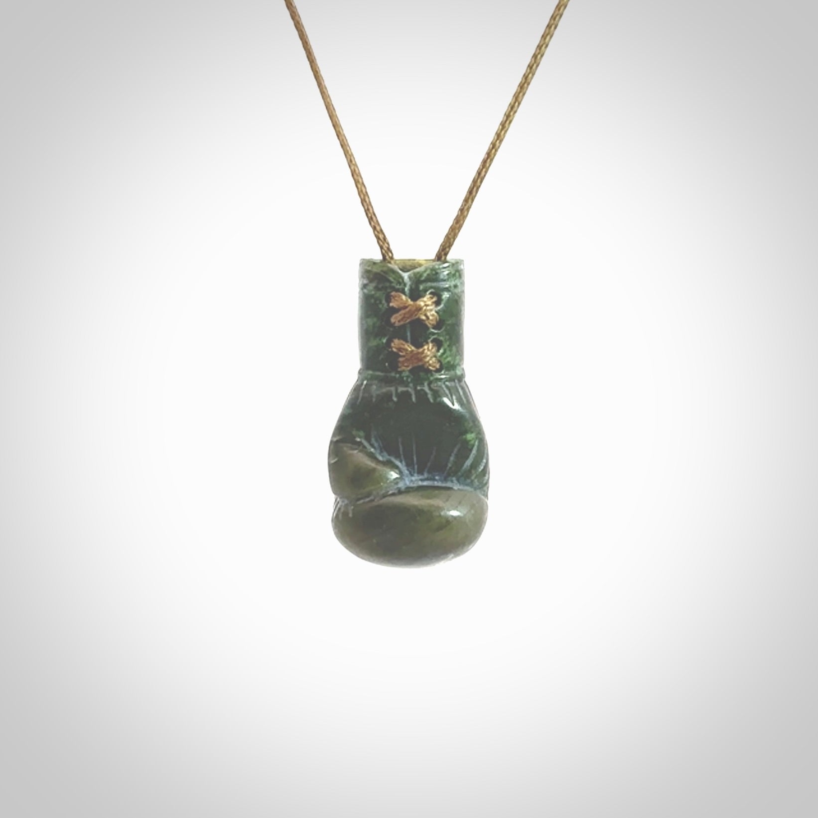 Hand carved boxing glove made from New Zealand Jade. The cord is adjustable so that you can wear this where it suits you best. The cost of shipping worldwide is included in the price.