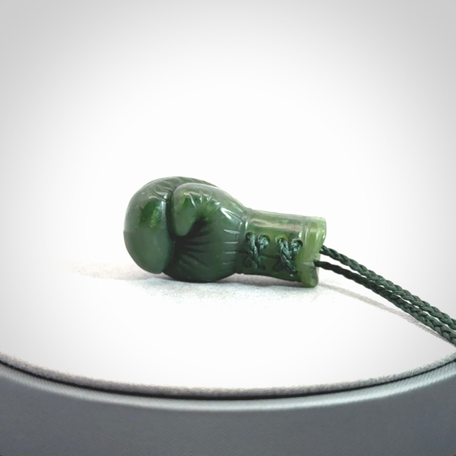 Hand carved boxing glove made from Jade. The cord is adjustable so that you can wear this where it suits you best. The cost of shipping worldwide is included in the price.