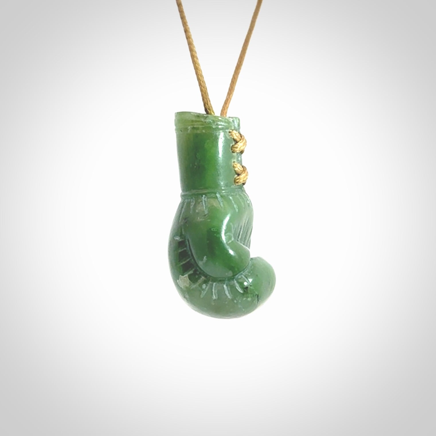 Hand carved boxing glove made from Jade. The cord is adjustable so that you can wear this where it suits you best. The cost of shipping worldwide is included in the price.