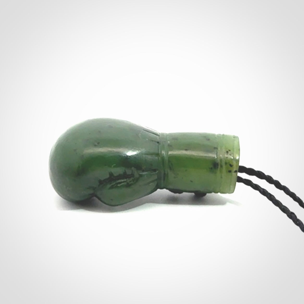Hand carved boxing glove made from Jade. The cord is adjustable so that you can wear this where it suits you best. The cost of shipping worldwide is included in the price.