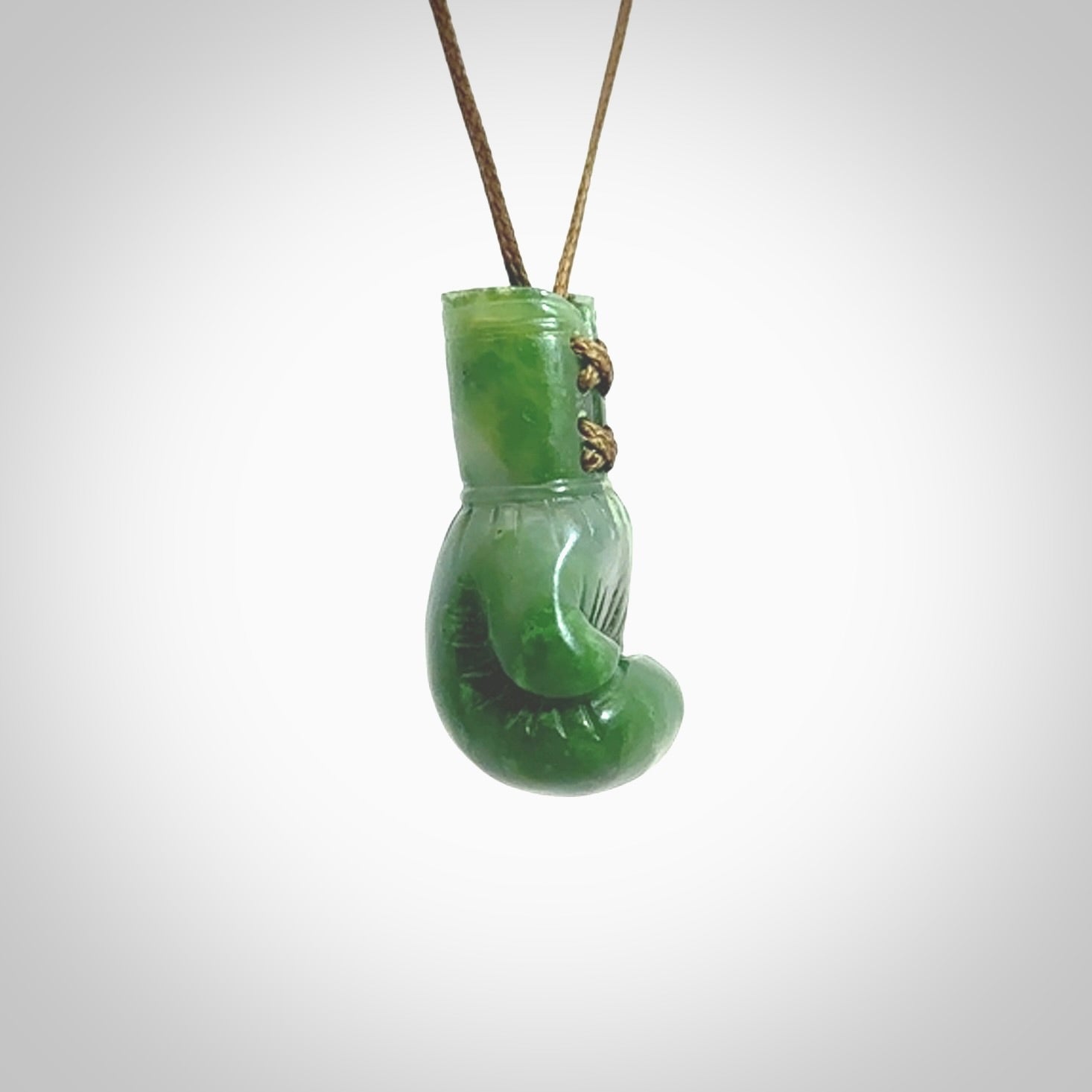 Hand carved boxing glove made from Jade. The cord is adjustable so that you can wear this where it suits you best. The cost of shipping worldwide is included in the price.