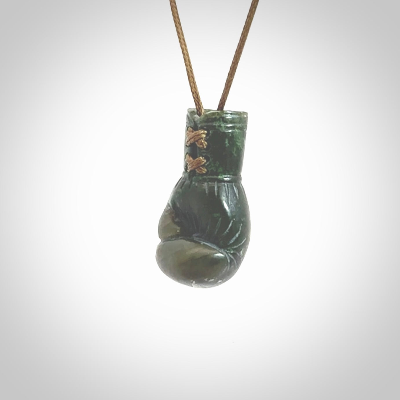 Hand carved boxing glove made from New Zealand Jade. The cord is adjustable so that you can wear this where it suits you best. The cost of shipping worldwide is included in the price.