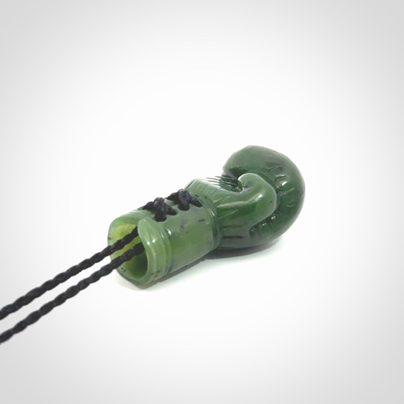 Hand carved boxing glove made from Jade. The cord is adjustable so that you can wear this where it suits you best. The cost of shipping worldwide is included in the price.