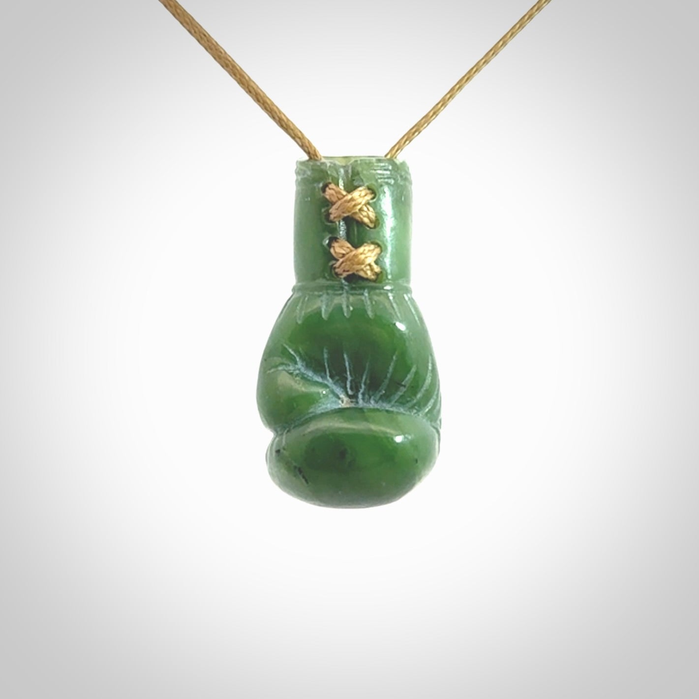 Hand carved boxing glove made from Jade. The cord is adjustable so that you can wear this where it suits you best. The cost of shipping worldwide is included in the price.