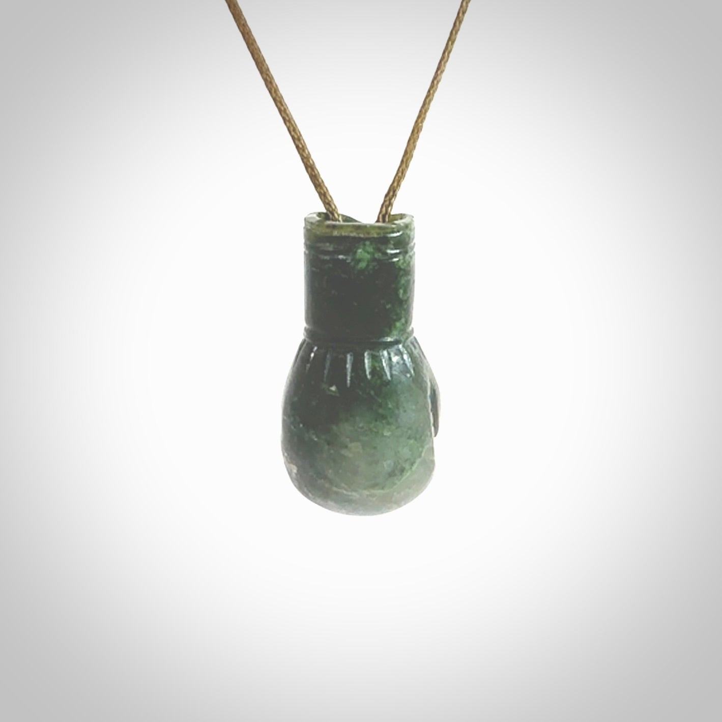 Hand carved boxing glove made from New Zealand Jade. The cord is adjustable so that you can wear this where it suits you best. The cost of shipping worldwide is included in the price.