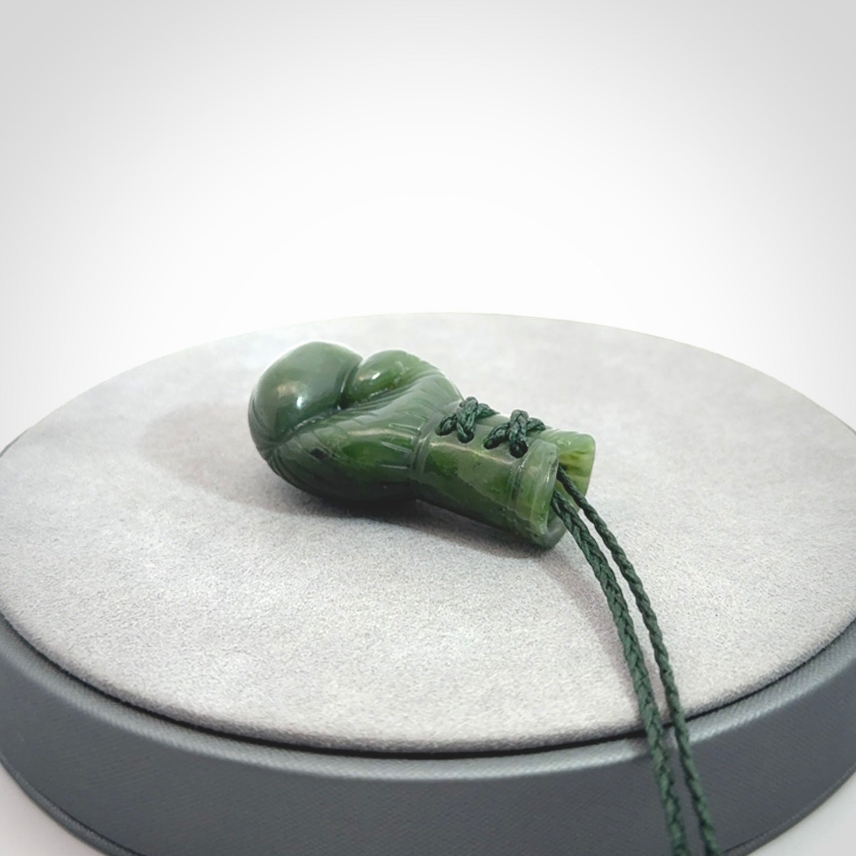 Hand carved boxing glove made from Jade. The cord is adjustable so that you can wear this where it suits you best. The cost of shipping worldwide is included in the price.