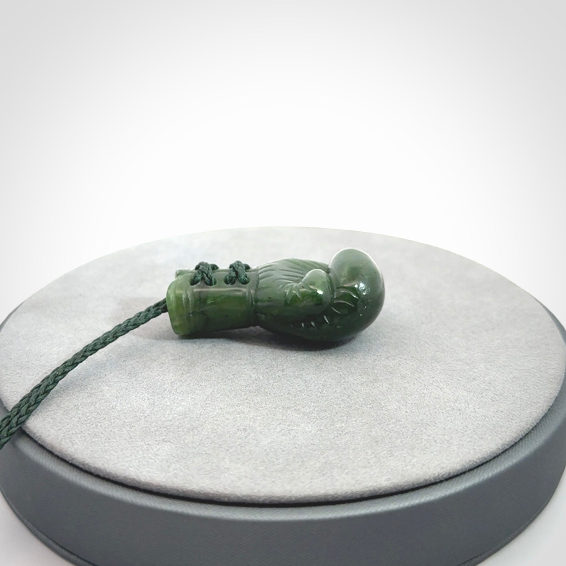 Hand carved boxing glove made from Jade. The cord is adjustable so that you can wear this where it suits you best. The cost of shipping worldwide is included in the price.