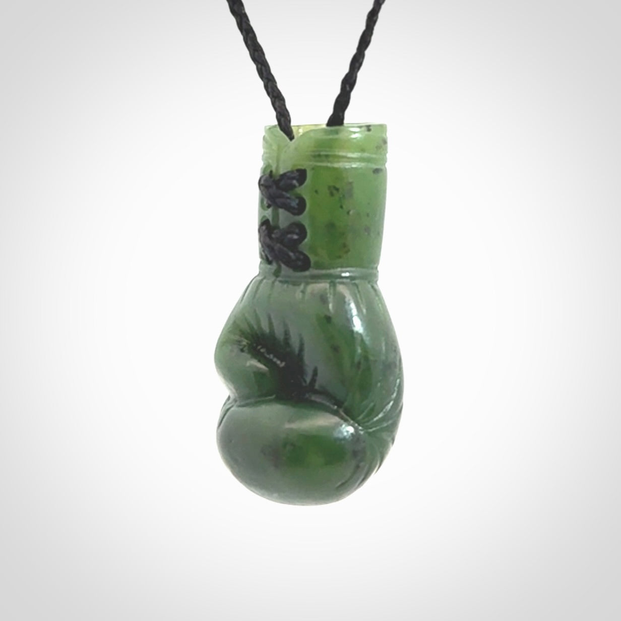 Hand carved boxing glove made from Jade. The cord is adjustable so that you can wear this where it suits you best. The cost of shipping worldwide is included in the price.