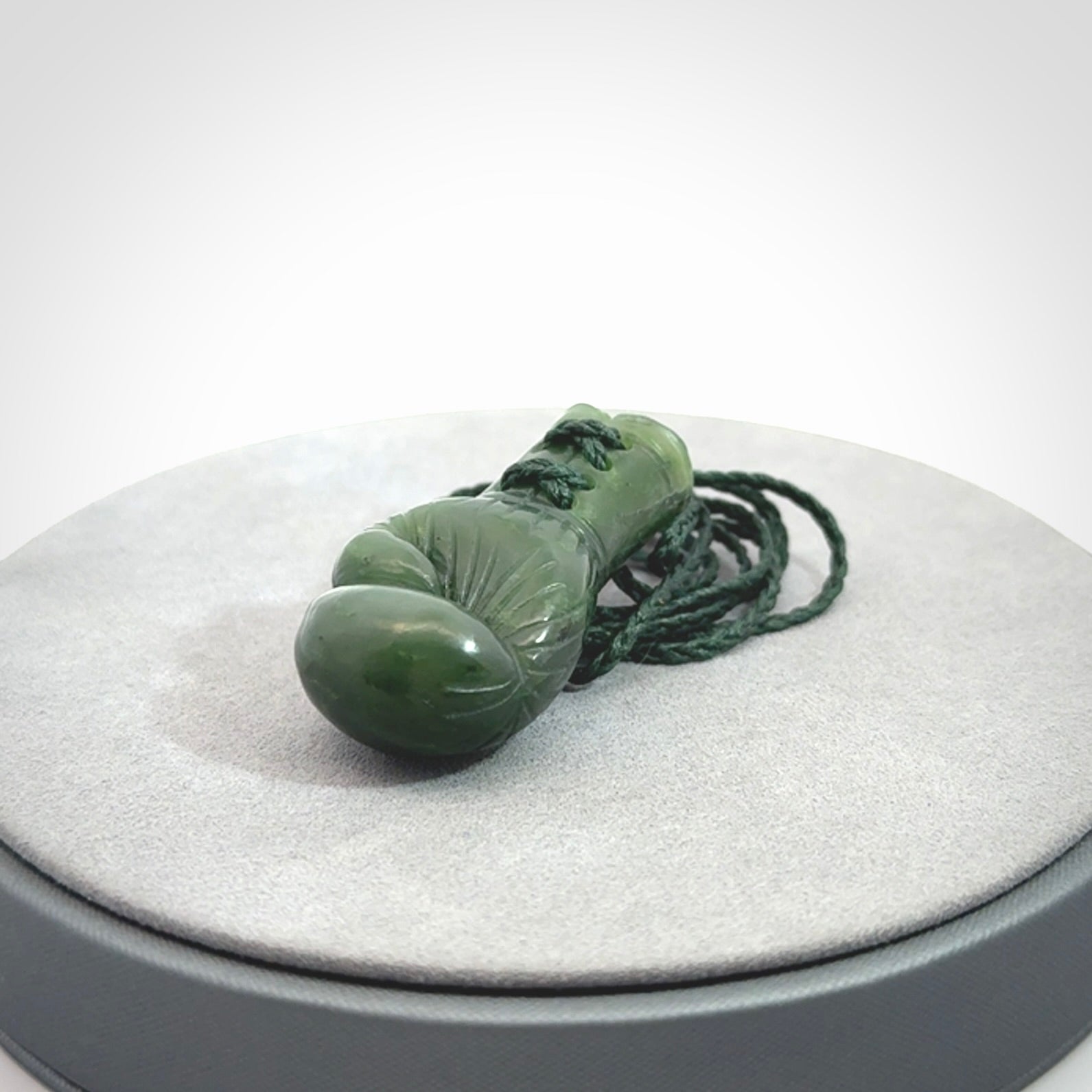 Hand carved boxing glove made from Jade. The cord is adjustable so that you can wear this where it suits you best. The cost of shipping worldwide is included in the price.
