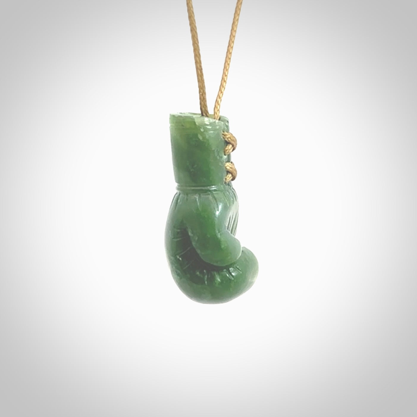 Hand carved boxing glove made from New Zealand Jade. The cord is adjustable so that you can wear this where it suits you best. The cost of shipping worldwide is included in the price.