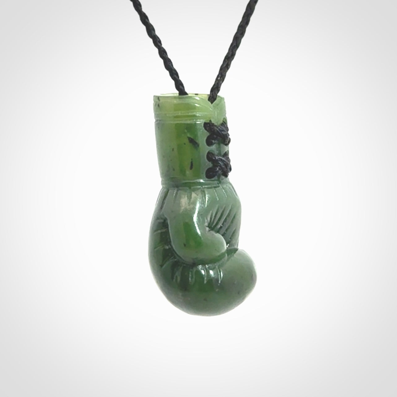 Hand carved boxing glove made from Jade. The cord is adjustable so that you can wear this where it suits you best. The cost of shipping worldwide is included in the price.