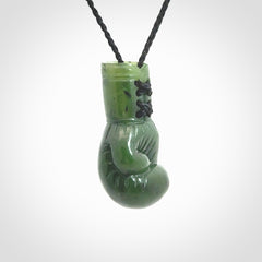 Hand carved boxing glove made from Jade. The cord is adjustable so that you can wear this where it suits you best. The cost of shipping worldwide is included in the price.