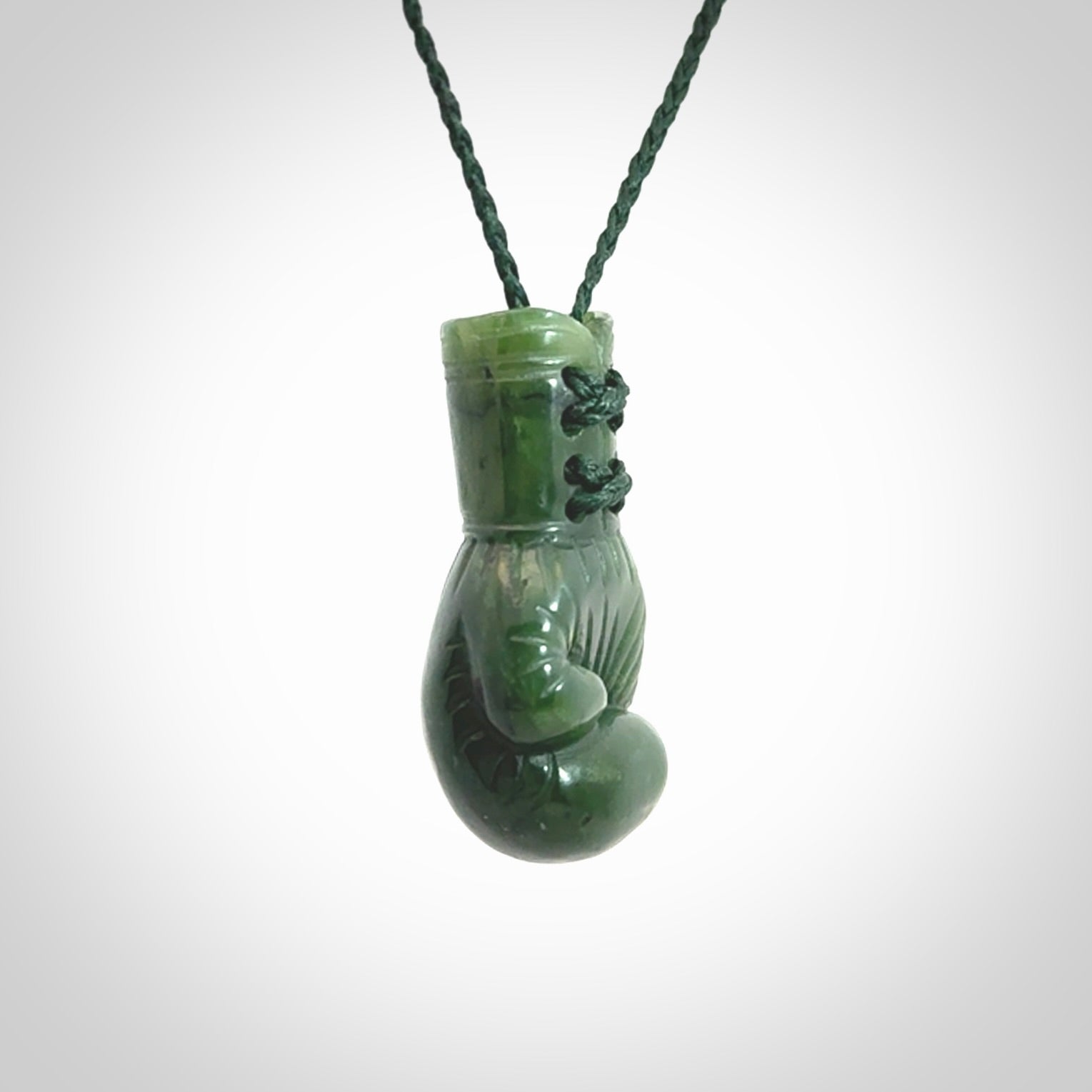 Hand carved boxing glove made from Jade. The cord is adjustable so that you can wear this where it suits you best. The cost of shipping worldwide is included in the price.