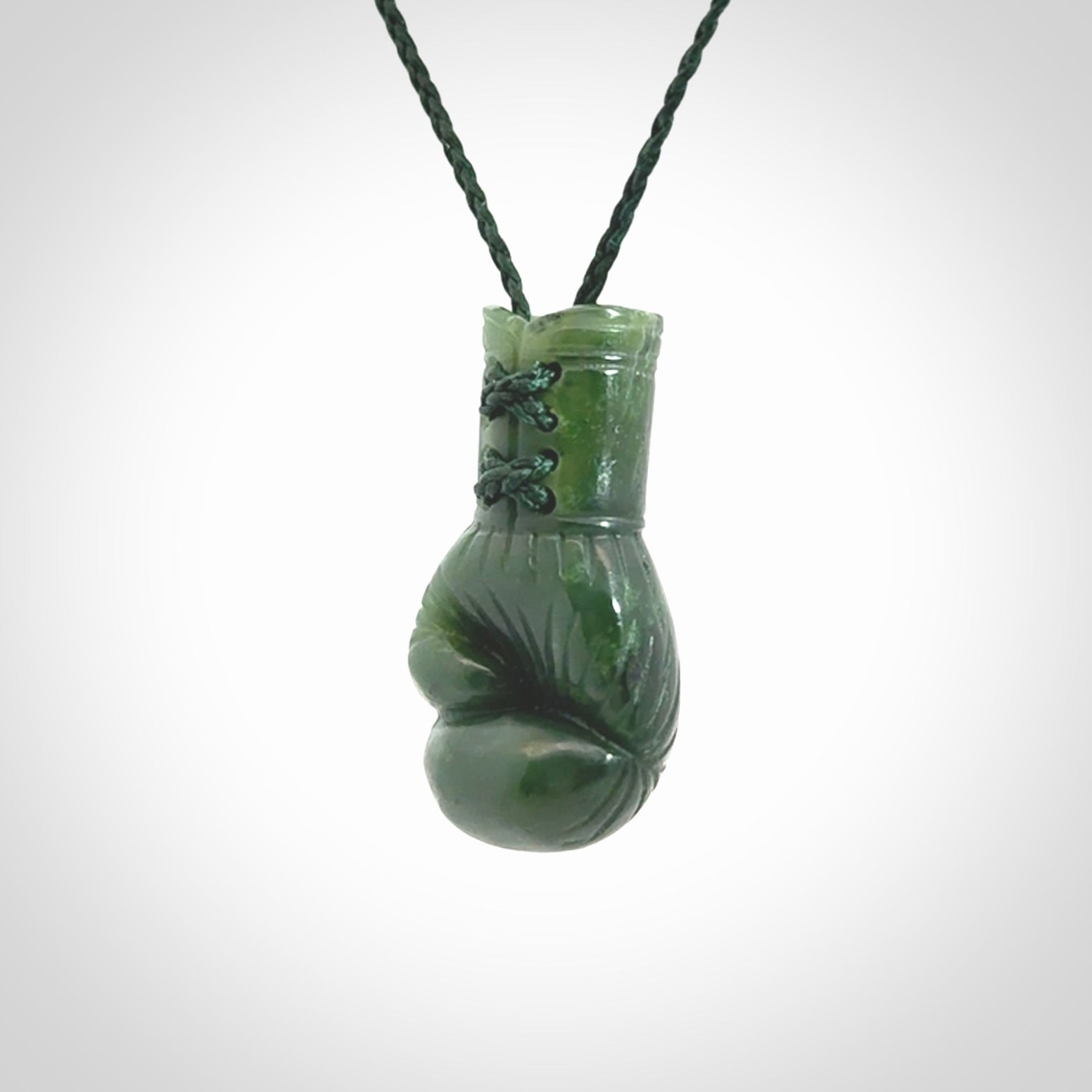Hand carved boxing glove made from Jade. The cord is adjustable so that you can wear this where it suits you best. The cost of shipping worldwide is included in the price.