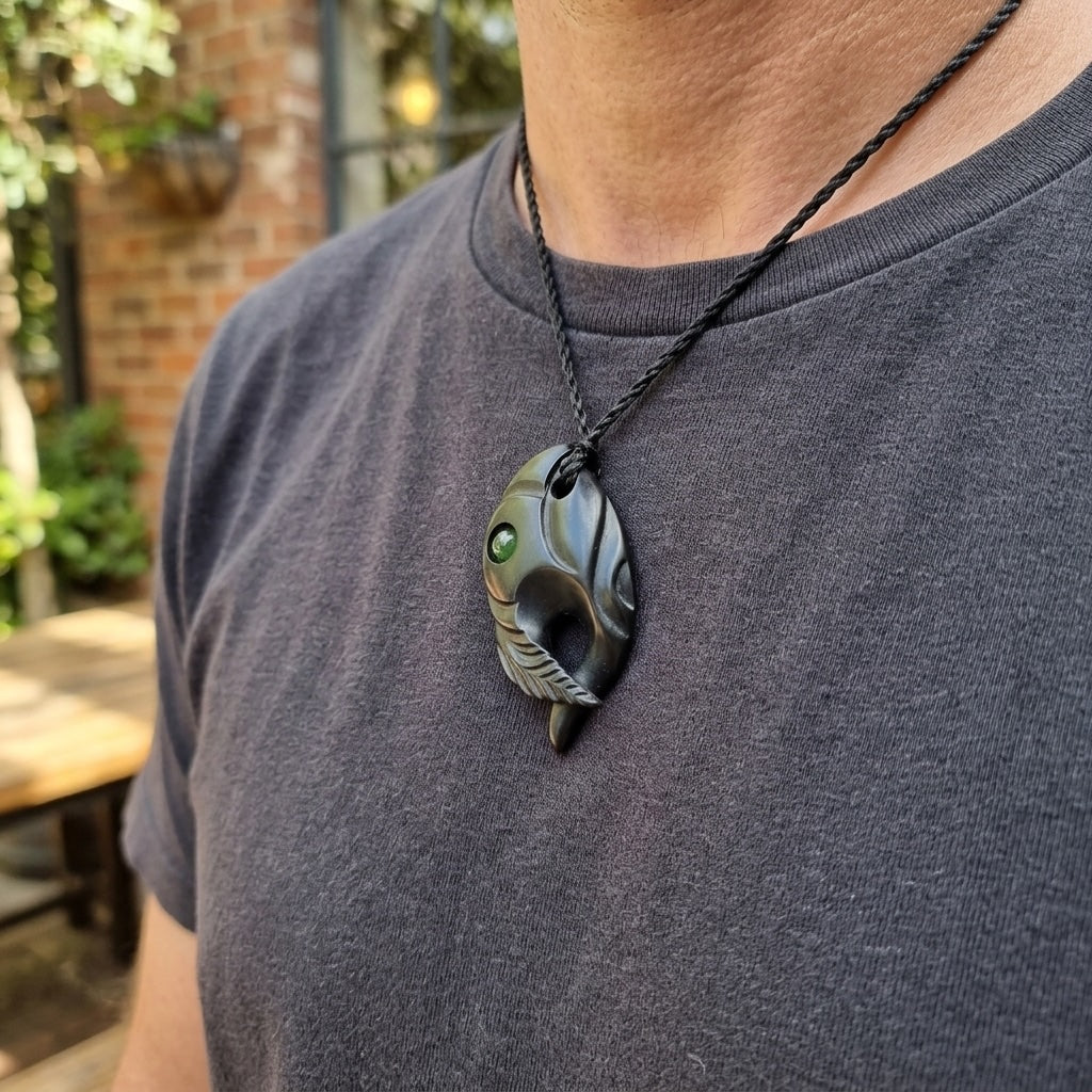 Man wearing black jade bird pendant