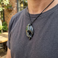 Man wearing black jade bird pendant