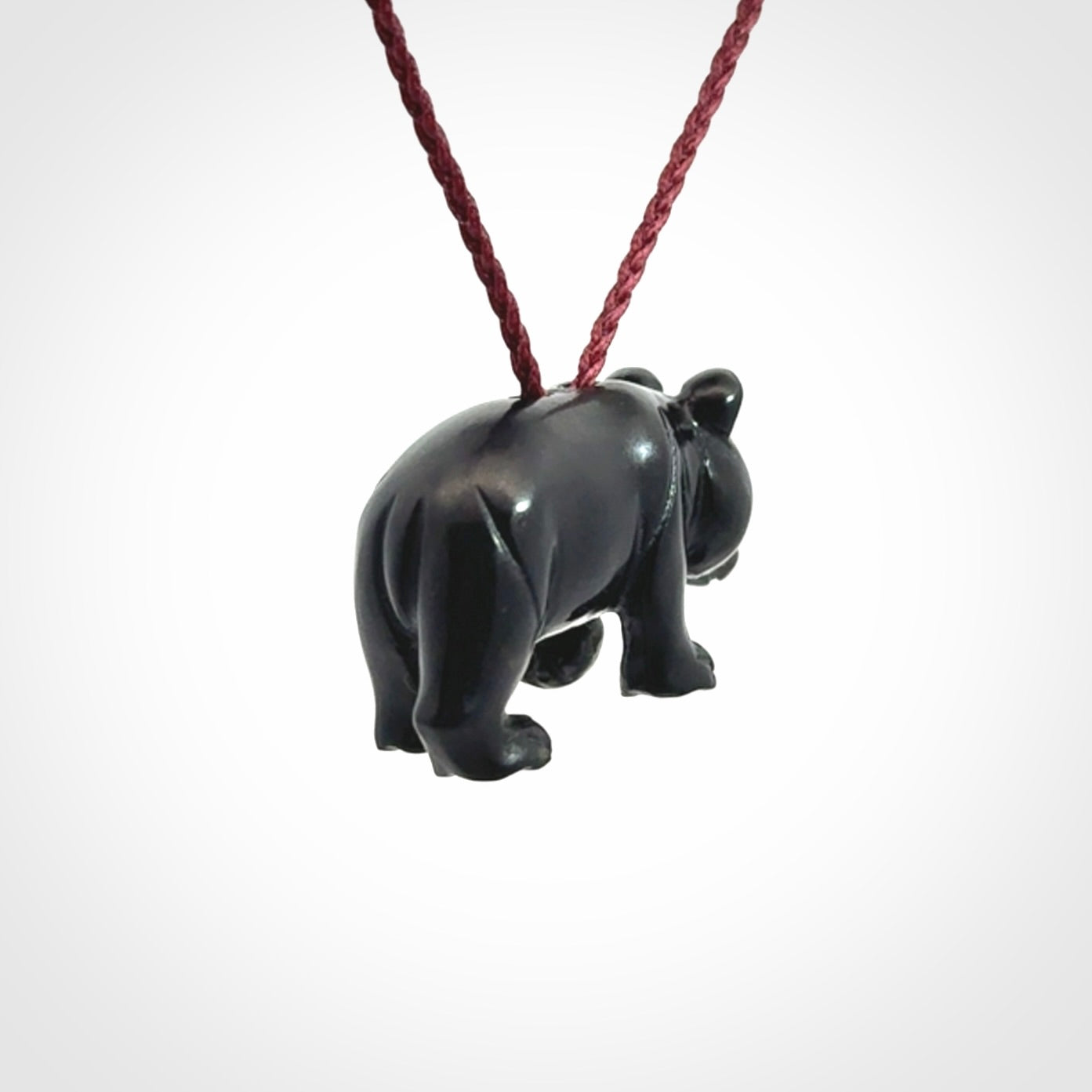 This picture shows a pendant that we designed in black jade. It is a little black bear that has a walking stance and is carved in detail. A really attractive and eye-catching piece of handmade jewellery. The cord is burgundy and the length can be adjusted.