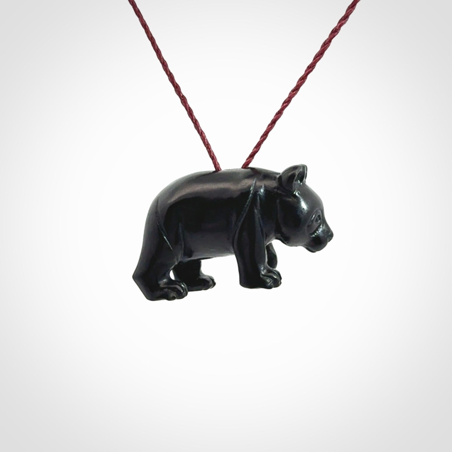This picture shows a pendant that we designed in black jade. It is a little black bear that has a walking stance and is carved in detail. A really attractive and eye-catching piece of handmade jewellery. The cord is burgundy and the length can be adjusted.