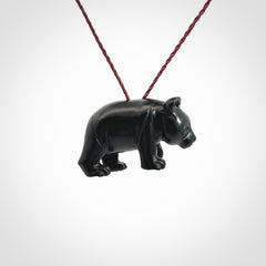 This picture shows a pendant that we designed in black jade. It is a little black bear that has a walking stance and is carved in detail. A really attractive and eye-catching piece of handmade jewellery. The cord is burgundy and the length can be adjusted.