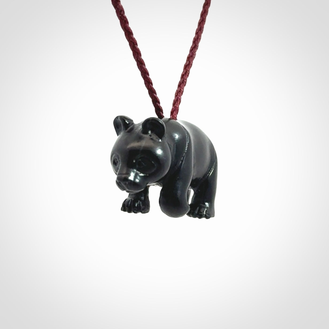This picture shows a pendant that we designed in black jade. It is a little black bear that has a walking stance and is carved in detail. A really attractive and eye-catching piece of handmade jewellery. The cord is burgundy and the length can be adjusted.