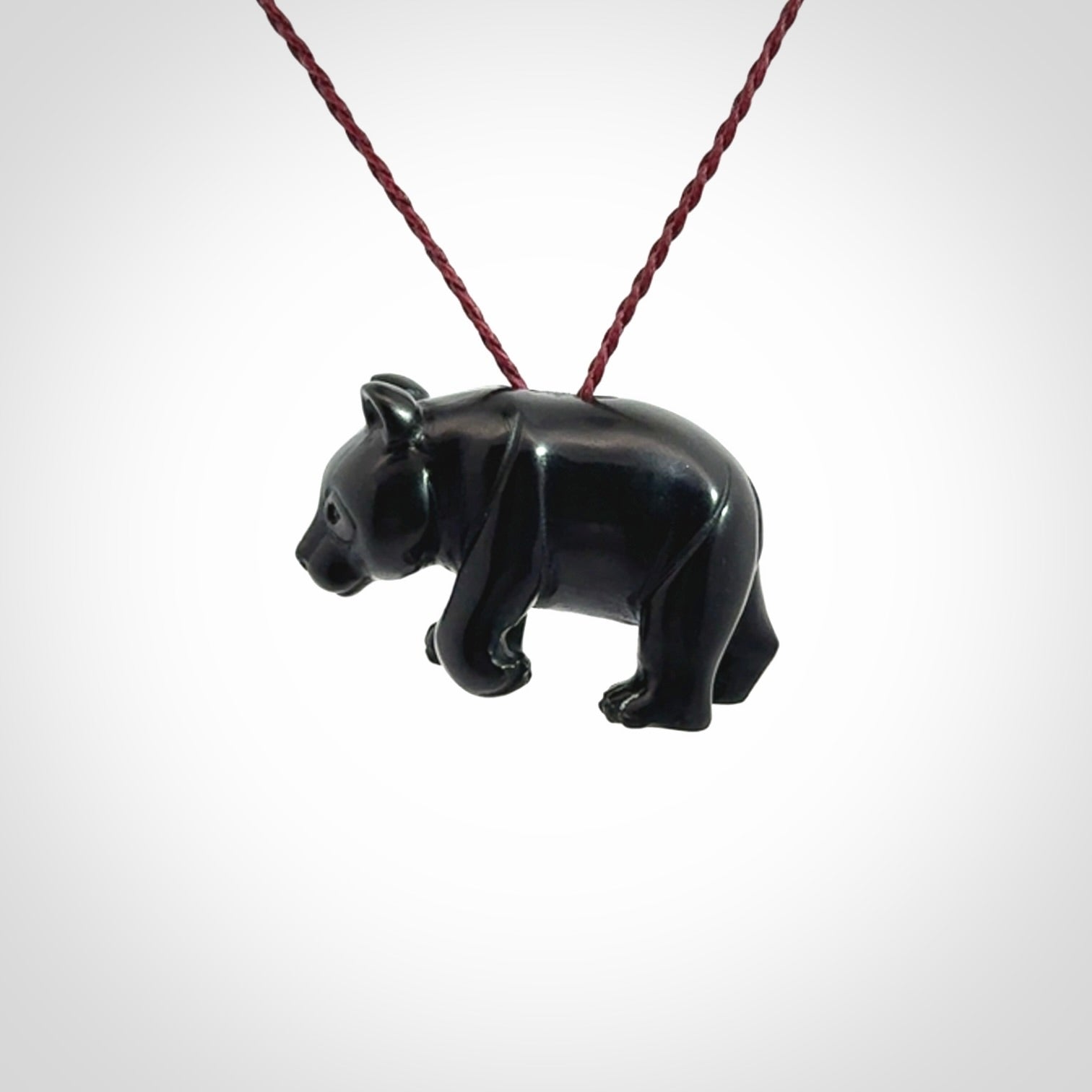 This picture shows a pendant that we designed in black jade. It is a little black bear that has a walking stance and is carved in detail. A really attractive and eye-catching piece of handmade jewellery. The cord is burgundy and the length can be adjusted.