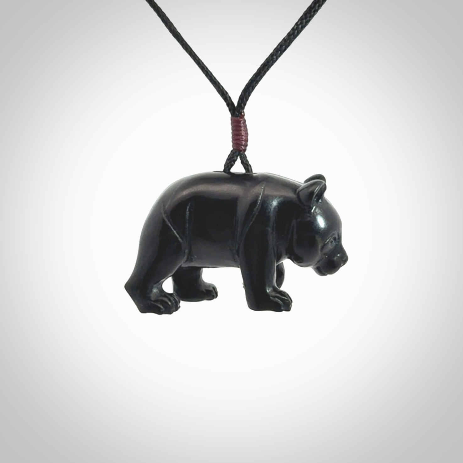 This picture shows a pendant that we designed in black jade. It is a little black bear that has a walking stance and is carved in detail. A really attractive and eye-catching piece of handmade jewellery. The cord is black and the length can be adjusted.