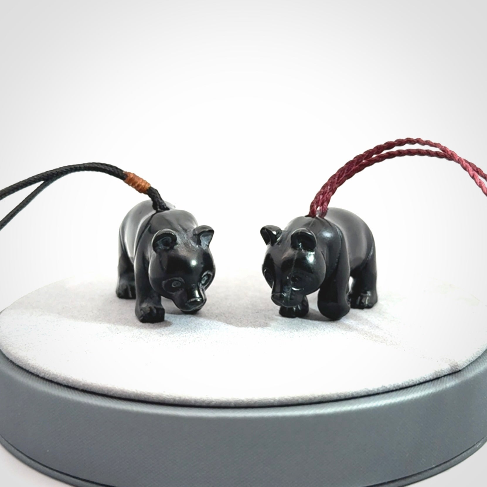 This picture shows a pendant that we designed in black jade. It is a little black bear that has a walking stance and is carved in detail. A really attractive and eye-catching piece of handmade jewellery. The cord is adjustable.