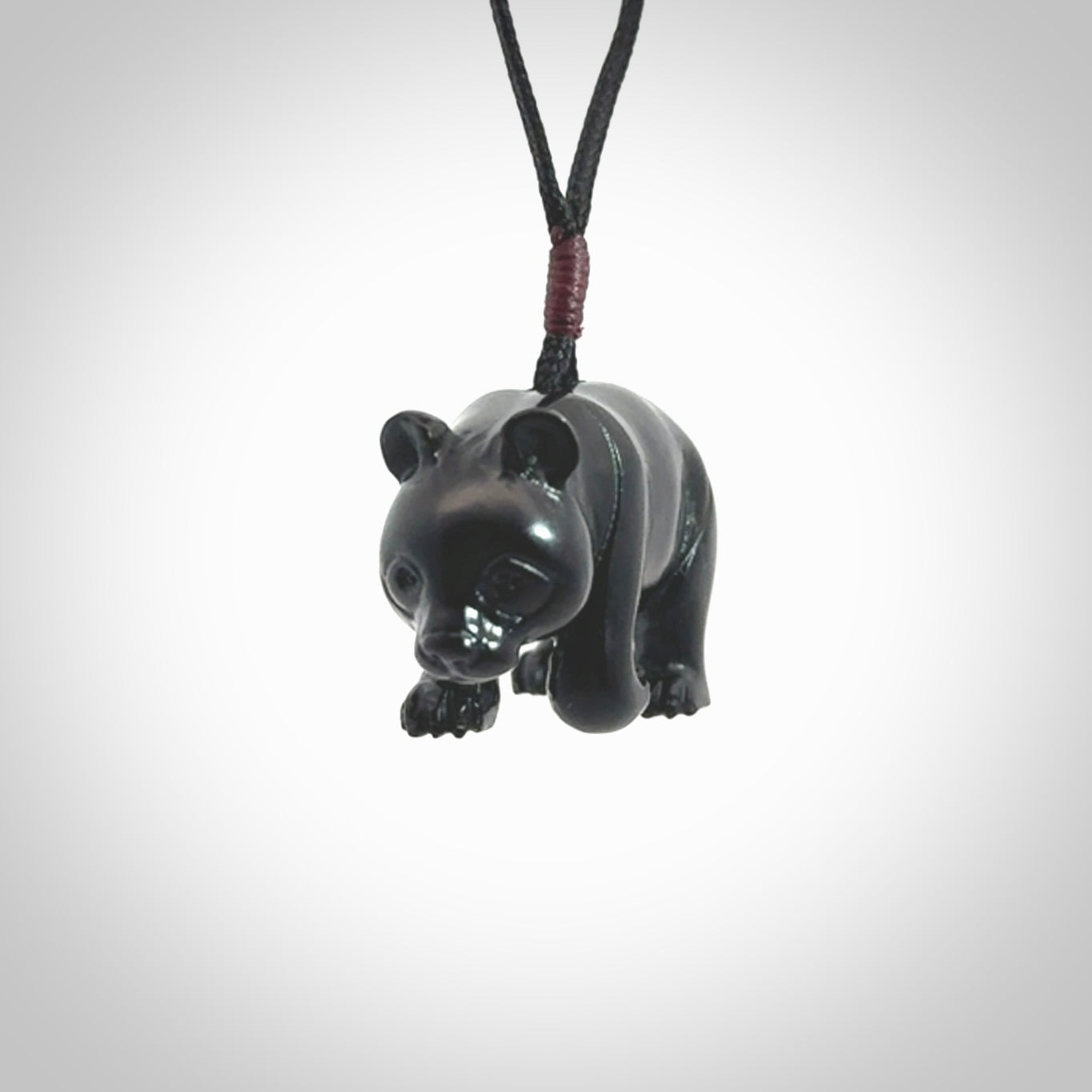 This picture shows a pendant that we designed in black jade. It is a little black bear that has a walking stance and is carved in detail. A really attractive and eye-catching piece of handmade jewellery. The cord is black and the length can be adjusted.