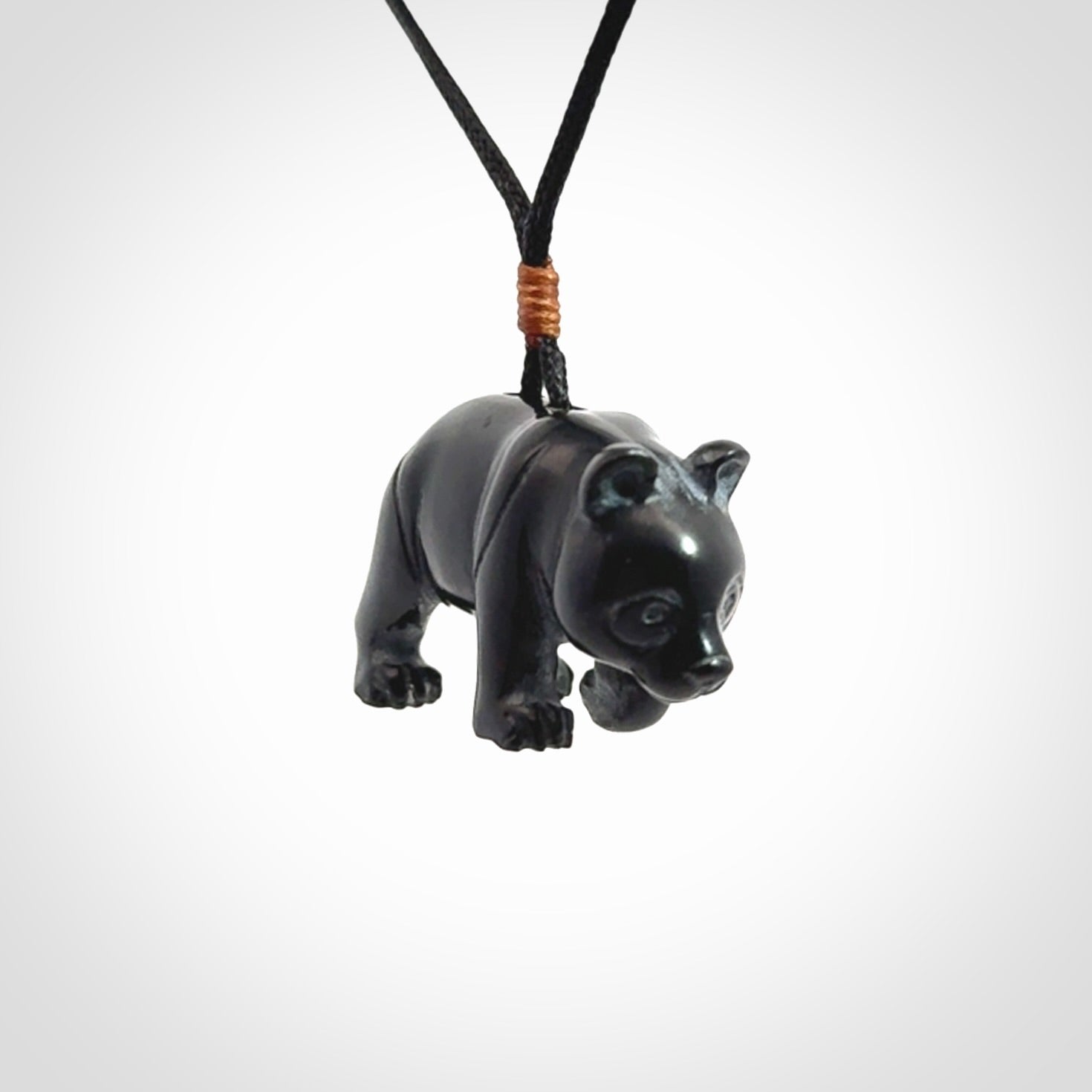This picture shows a pendant that we designed in black jade. It is a little black bear that has a walking stance and is carved in detail. A really attractive and eye-catching piece of handmade jewellery. The cord is black and the length can be adjusted.