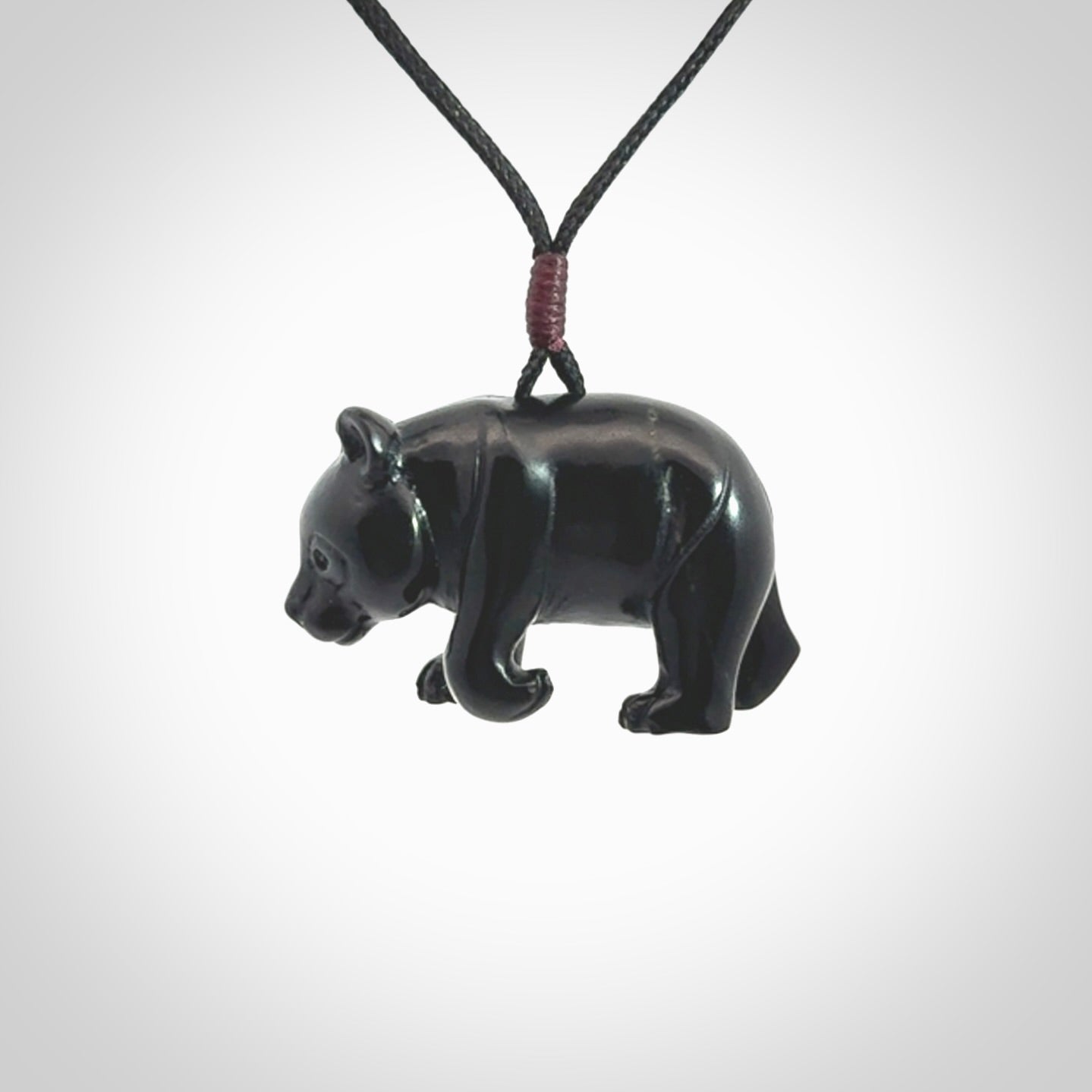 This picture shows a pendant that we designed in black jade. It is a little black bear that has a walking stance and is carved in detail. A really attractive and eye-catching piece of handmade jewellery. The cord is black and the length can be adjusted.